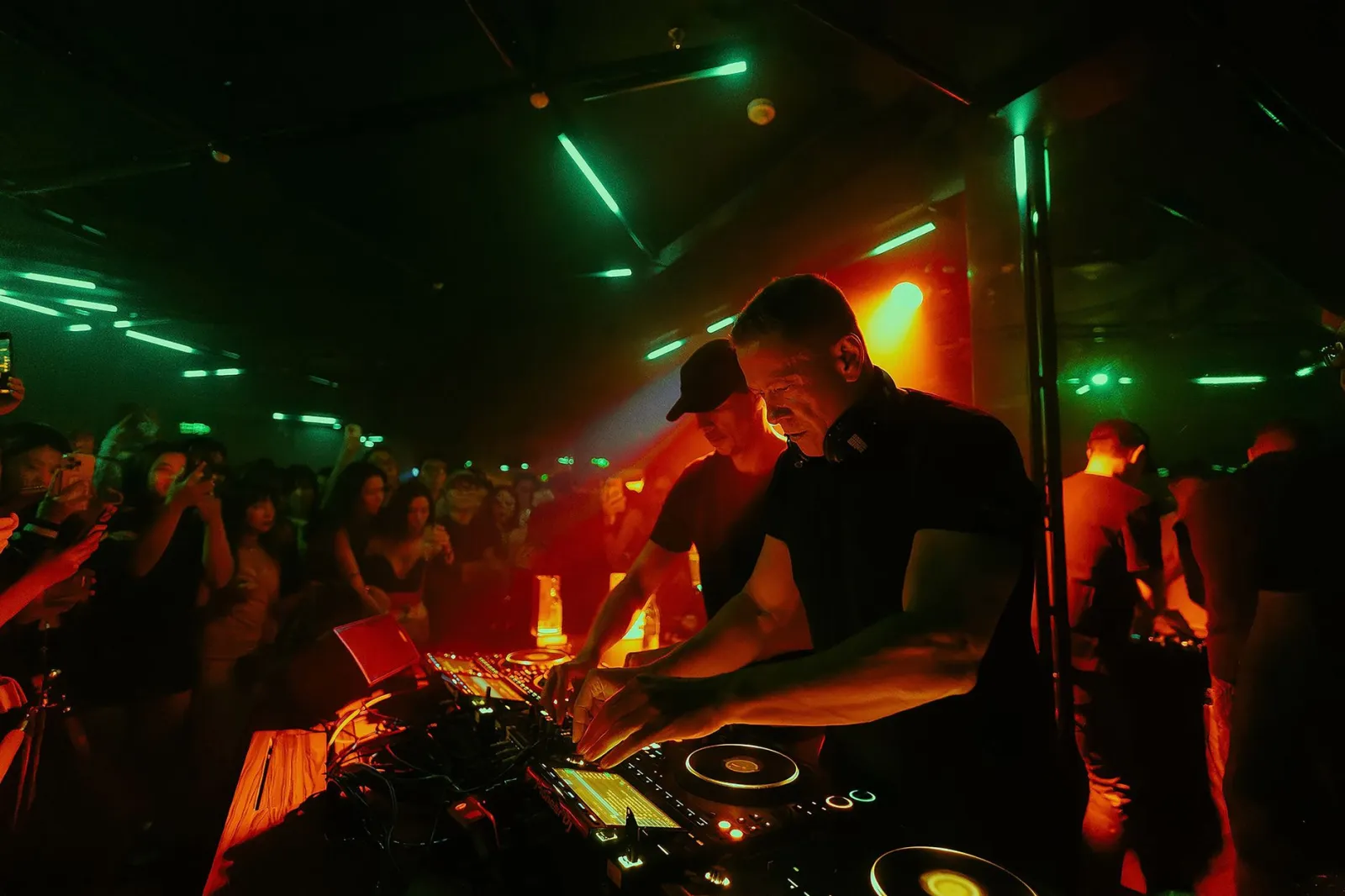 Exciting DJ performance in a crowded nightclub, capturing vibrant nightlife energy.
